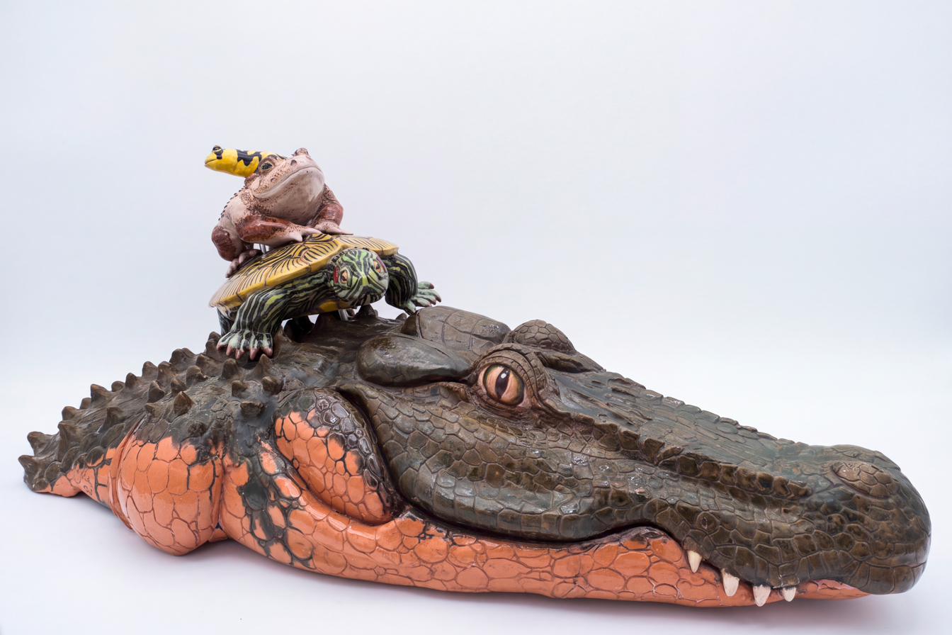 Glazed ceramic water fountain sculpted as a large alligator with a toad and a painted turtle perched together on top of its head