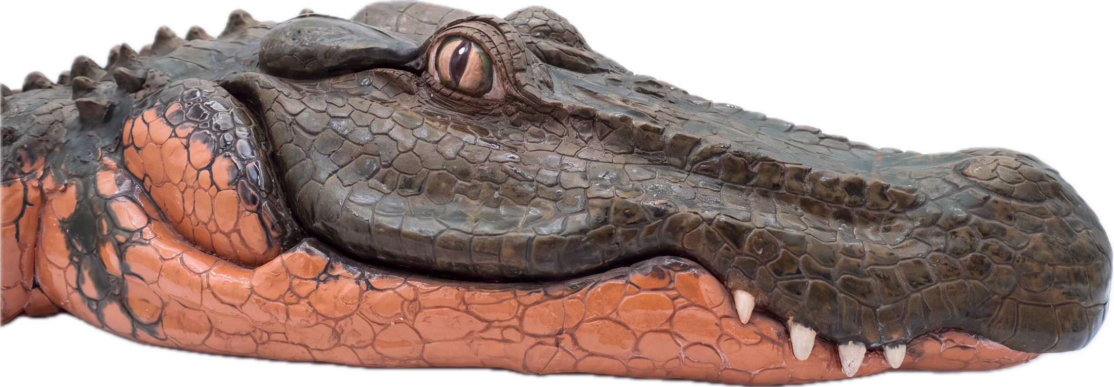 Close-up of a glazed ceramic alligator fountain sculpture, its head and scaled back resting in profile